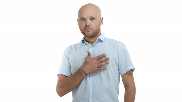 Handsome Adult Bald Man with Beard Wearing Casual Blue Shirt Looking Shocked and Impressed Raising