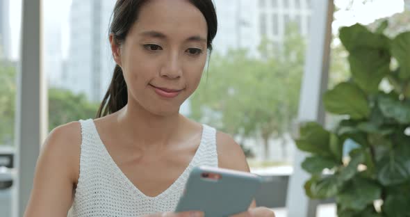 Woman using mobile phone in Hong Kong city