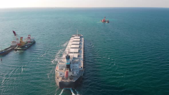 The Bulk Carrier Left the Port and Moves in the Right Direction at High Speed.