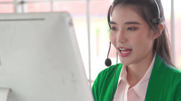 Businesswoman Wearing Headset Working Actively in Office