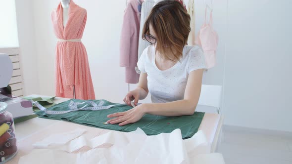 Dressmaker, Tailor and Fashion Concept - Female Clothing Designer at Workplace in Studio