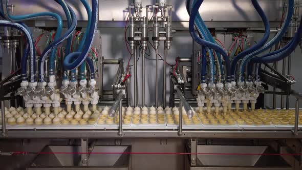 Ice Cream Production Line. Filling of Wafer Cups with Ice Cream. Ice Cream Factory