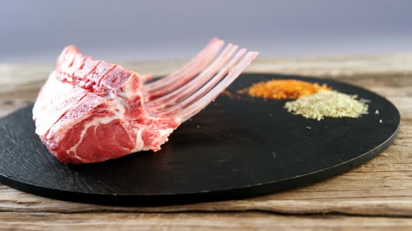 Raw beef ribs and ingredients on wooden board
