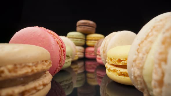 Colored Macaroons Confectionery Marshmallows on a Black Reflective Background in Perspective