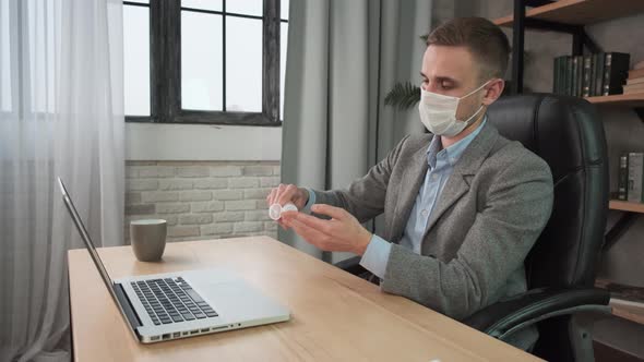 Young Man Applying Sanitizer Gel Rubbing Hands Before Distance Computer Work From Home Office on