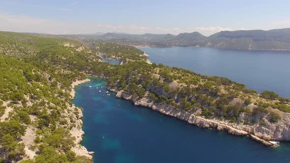 Aerial travel drone view of clear green water, cliffs of Cassis, Mediterranean Sea, Southern France.