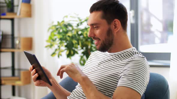 Smiling Man with Tablet Pc Computer at Home