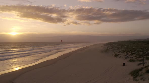 Beautiful Sunset at Ocean Coastline with Single Kite Surfer