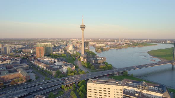 Rhine tower and morning traffic crossing Rhine bridge  in Dusseldorf, Drone aerial shot