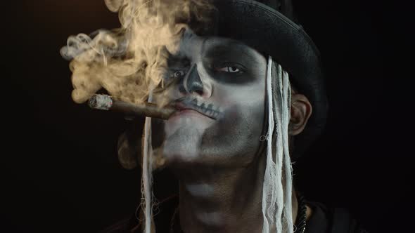 Frightening Man in Skeleton Halloween Cosplay Costume Smoking Cigar, Making Faces, Smiling