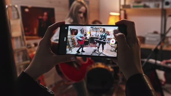 Filming Video Of Female Rock Band Giving Concert