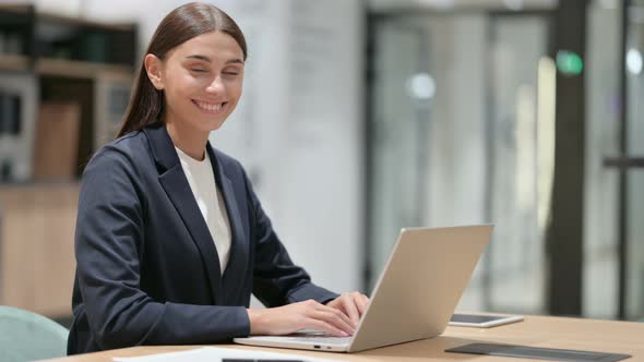 Cheerful Businesswoman with Laptop Smiling at Camera 