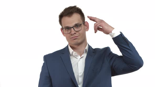 Tired Businessman in Blue Suit and Glasses Making Finger Gun Gesture Shooting Himself in Head From