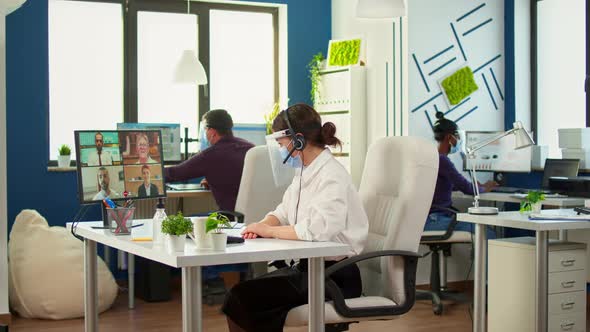 Entrepreneur Wearing Face Mask Discussing on Video Meeting