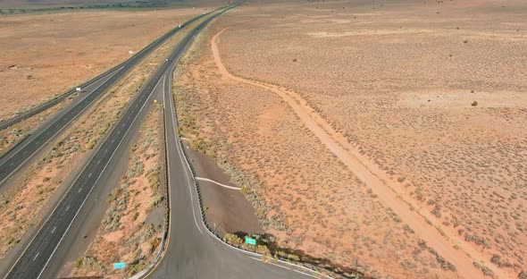 Top View of Asphalt Interstate Roadside Crossing on Desert Environment in USA Aerial Scenery View