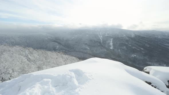 A Snowcovered Hilly Winter Landscape with Woods  Top View