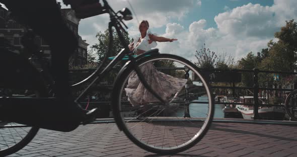 Woman spins Hula Hoop on canal