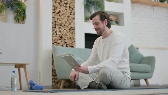 Young Man Doing Video Call on Tablet in Kitchen