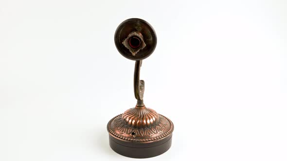 Fake Bronze Sconce Spinning on Turning Table on White Background