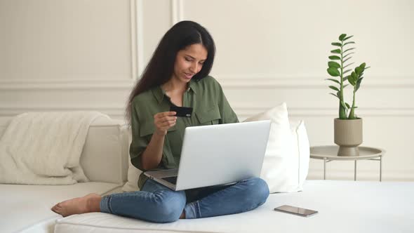 Happy Indian Woman Holds Debit Card and Shopping Online