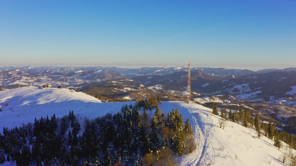 Flying Over Radio Communications Tower Mountain Snow Covered Winter Landscape