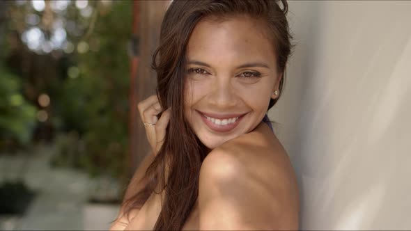 Attractive Woman with Naked Shoulders Looking at Camera and Smiling