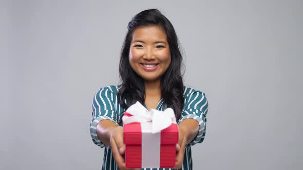 Smiling Young Asian Woman Holding Gift Box