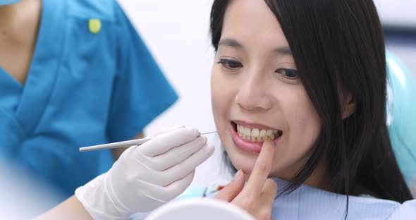 Dentist examining a patient teeth in the dentist