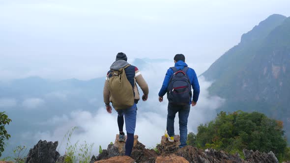 Two Male Hiking and Celebrating on Mountain Peak