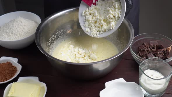 Closeup View of Male Hands Preparing Dough Adding Cottage Cheese in Bowl