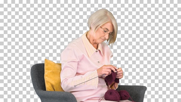 Elderly woman knitting sitting on a chair, Alpha Channel