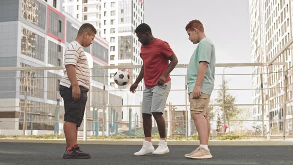 Father and Sons Training Football Outdoors
