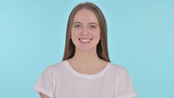 Portrait of Smiling Beautiful Young Woman, Blue Background