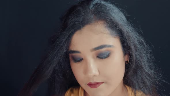 Close up of hairdresser making a hairstyle to beautiful young woman