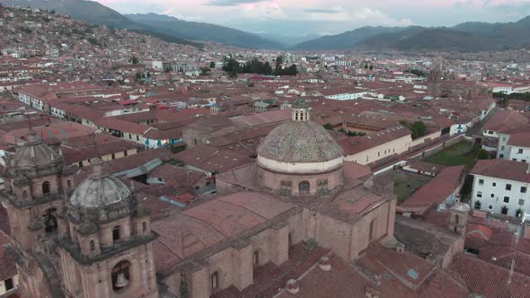 4k daytime aerial drone footage over the Church of the Society of Jesus from Plaza de Armas in Cusco