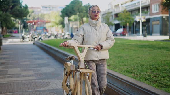 Female with Bicycle Walking in Park
