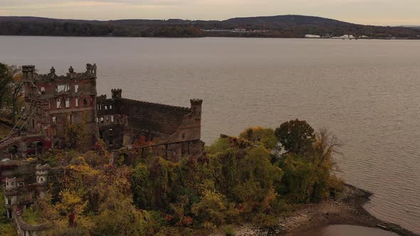 aerial drone camera flight towards Bannerman's Castle over the Hudson River in Beacon, NY on a cloud