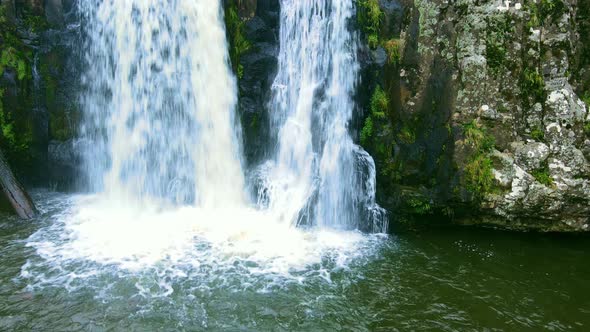 Waterfall Reaching a Lake. Drone Footage, Vertical Motion.