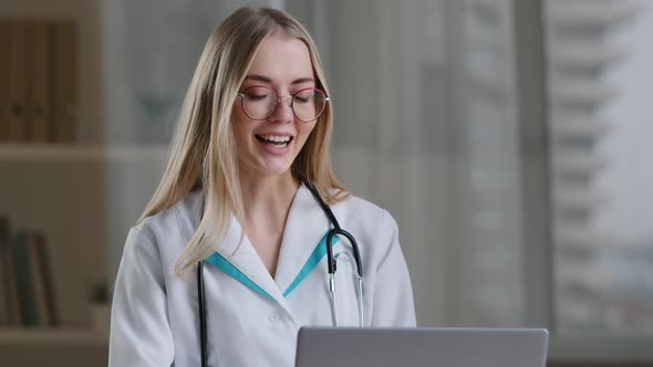 Female Nurse Caucasian Woman Medical Assistant in Glasses Video Calling Distant Patient on Laptop