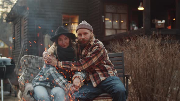 Portrait of Loving Couple Embracing by Bonfire