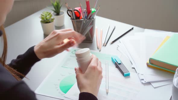 Close Up of Woman Office Worker Taking Her Medication During the Working Day