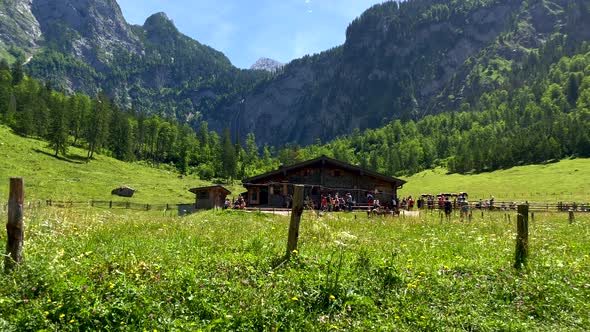 Hiker tourist take break in mountain chalet after strong exhaust hike in summer - Slow motion wide s