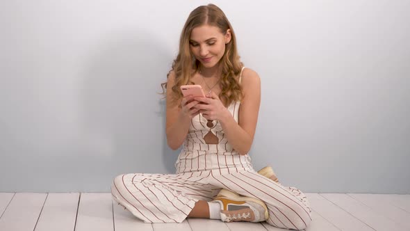 Young beautiful smiling girl in trendy summer clothes posing indoors