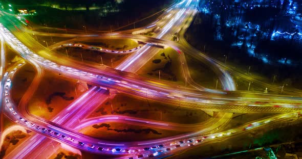 Beautiful top view time-lapse of car traffic at roundabout lane and buildings. 