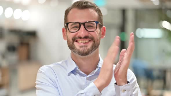 Portrait of Excited Businessman Clapping, Cheering 