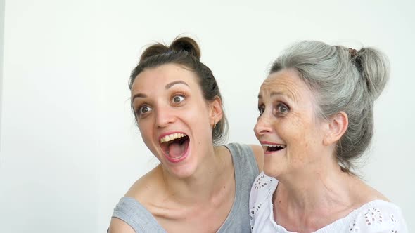 Happy Senior Mother is Hugging Her Adult Daughter the Women are Laughing Together Sincere Family of