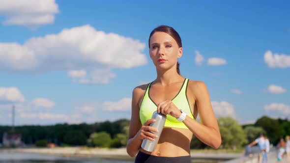 Woman Running and Drinking Water From Bottle