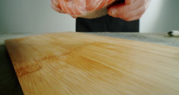 Chef Puts Herring Fish to the Wooden Board