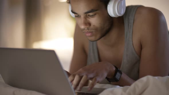 Black Man Using Laptop at Night