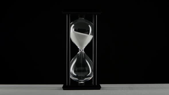 Isolated Hourglass. Hourglass with White Sand. Black